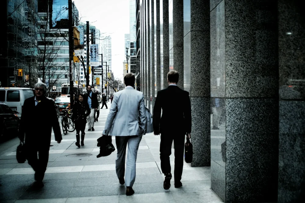 Back view of two businessmen walking in a hurry.