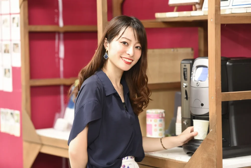 Female employee making benefit coffee in her office