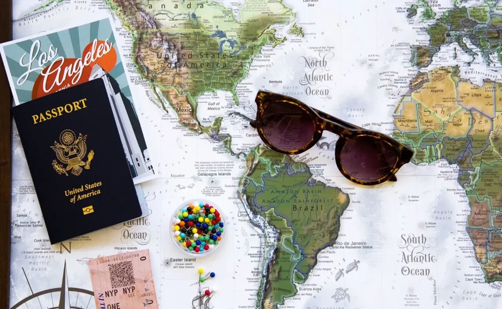 Passports and airline tickets are placed on a map of the world.
